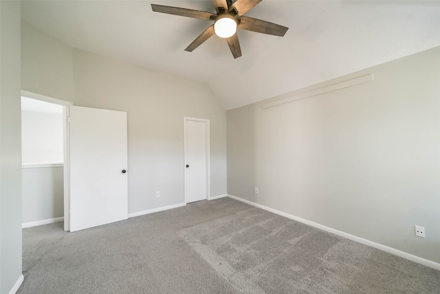 unfurnished bedroom featuring ceiling fan, carpet flooring, and lofted ceiling