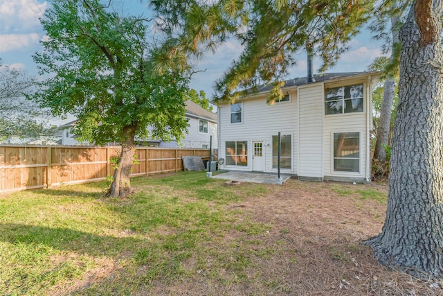 rear view of property with a patio area and a lawn