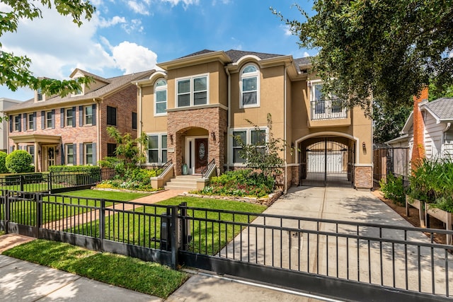 view of front of house with a front yard and a balcony