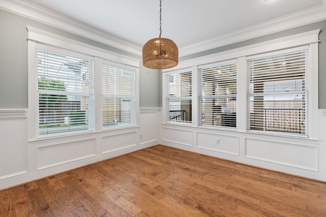 interior space with ornamental molding, wood-type flooring, and a healthy amount of sunlight