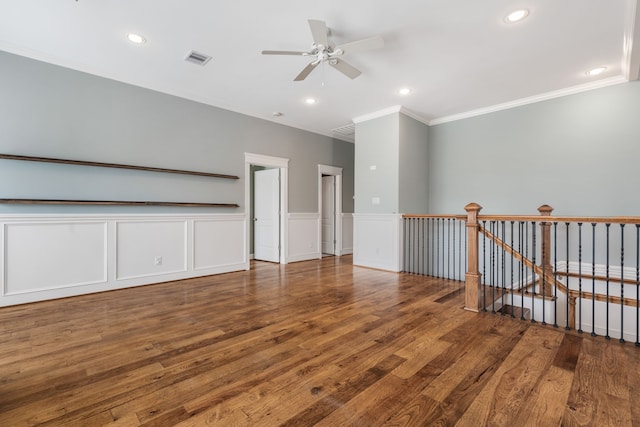 empty room featuring crown molding, hardwood / wood-style flooring, and ceiling fan