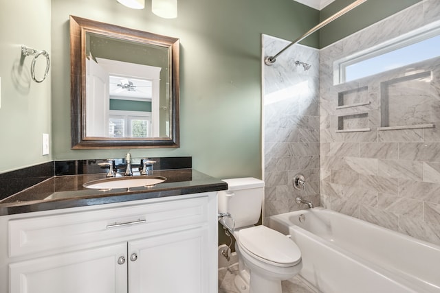 full bathroom with toilet, tiled shower / bath, and vanity