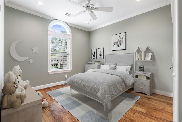 bedroom with ceiling fan, ornamental molding, and light wood-type flooring