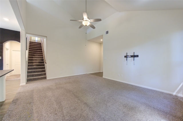 unfurnished living room featuring light colored carpet, high vaulted ceiling, and ceiling fan