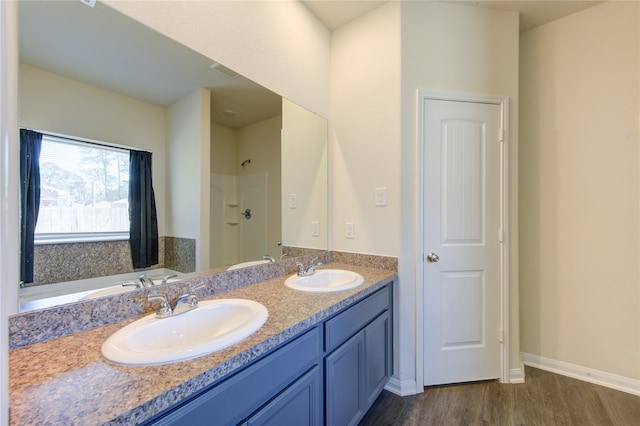 bathroom featuring vanity, hardwood / wood-style floors, and a tub