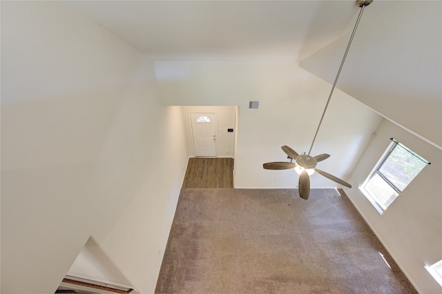 interior space with carpet floors and ceiling fan