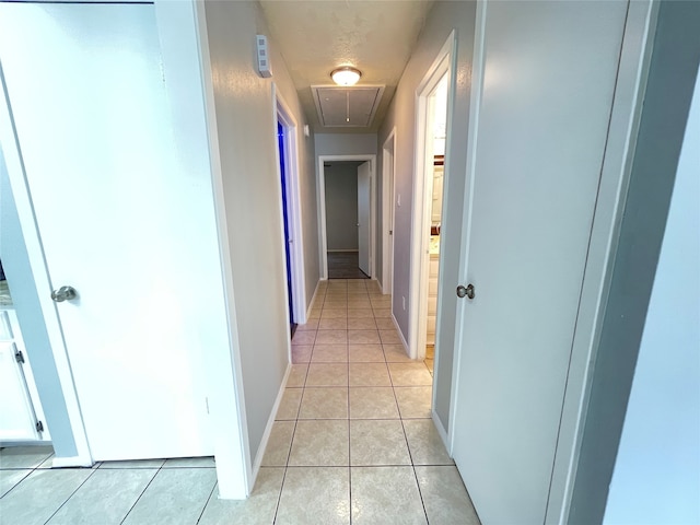 corridor featuring light tile patterned floors