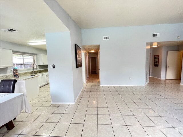 spare room with sink and light tile patterned floors