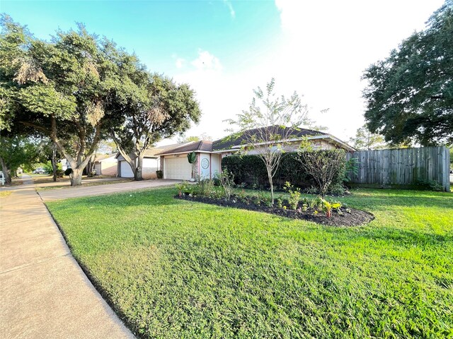 single story home featuring a garage and a front lawn