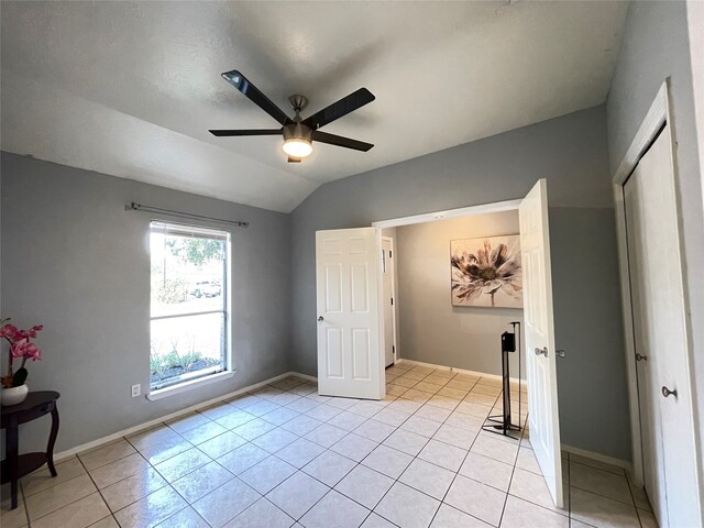 tiled bedroom with vaulted ceiling and ceiling fan