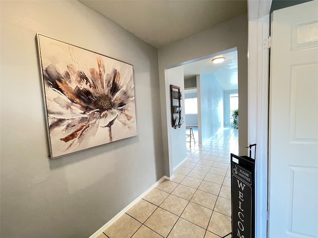 corridor featuring light tile patterned floors