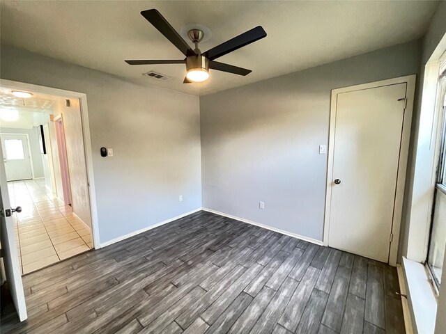 unfurnished room with ceiling fan and hardwood / wood-style floors