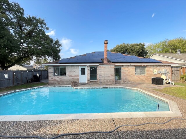 view of swimming pool with a patio and central AC unit