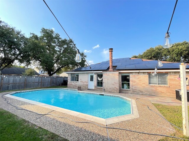 view of swimming pool with a patio and central air condition unit