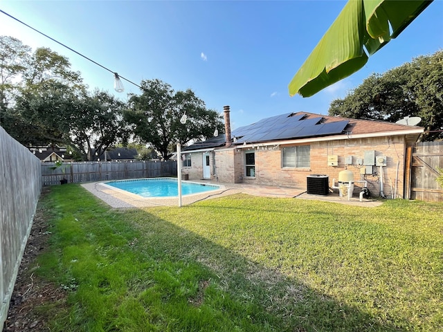 view of pool featuring a patio, central air condition unit, and a lawn