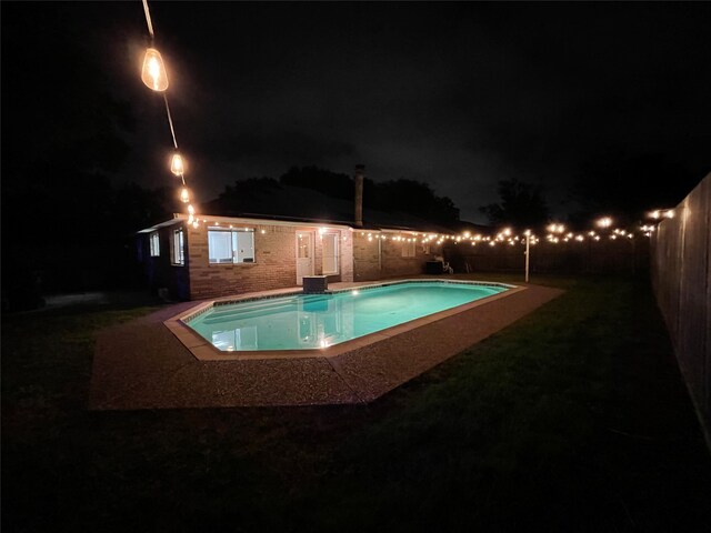 pool at twilight with a yard