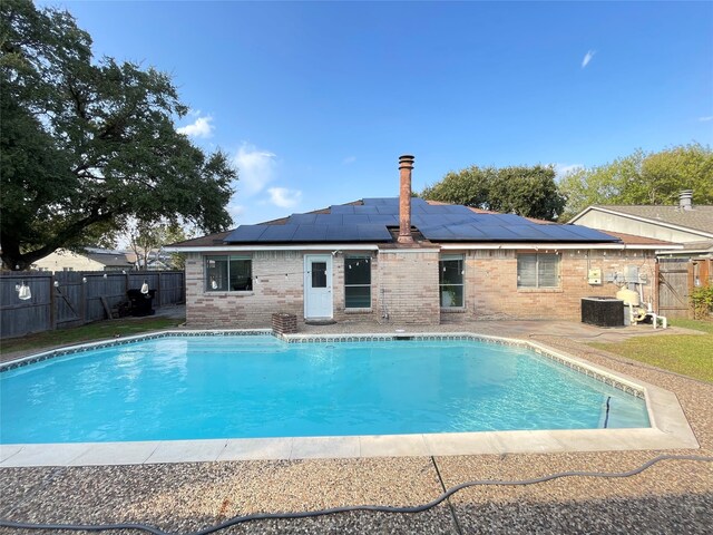 view of swimming pool with a patio area and central AC unit