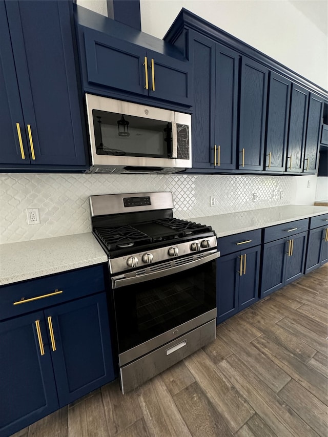 kitchen featuring appliances with stainless steel finishes, dark hardwood / wood-style flooring, and blue cabinets