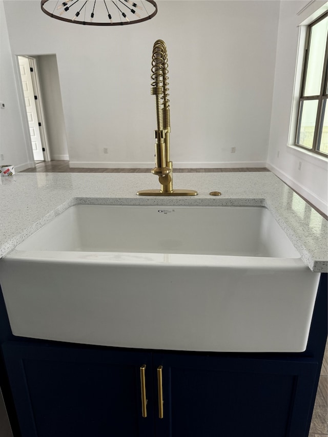 interior details featuring sink and blue cabinets