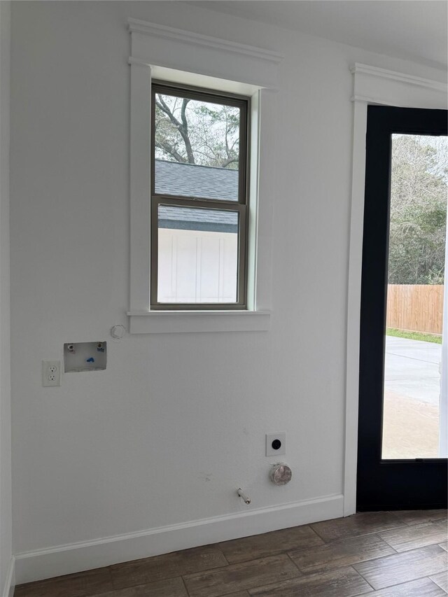 laundry area featuring gas dryer hookup, hookup for an electric dryer, dark wood-type flooring, washer hookup, and baseboards