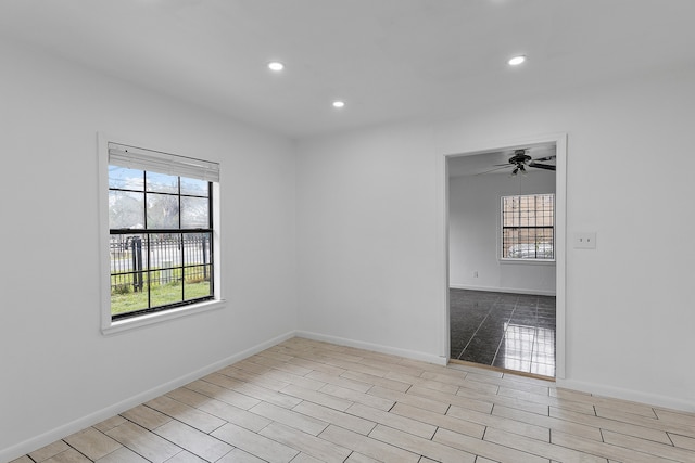 empty room with a healthy amount of sunlight and ceiling fan