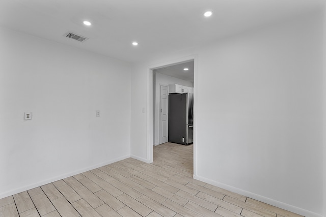 unfurnished room with light hardwood / wood-style floors