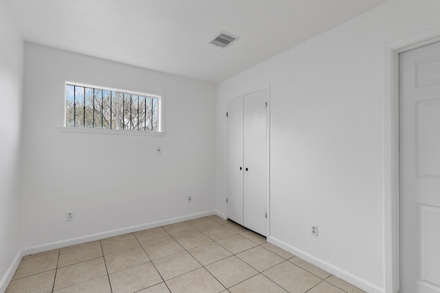 unfurnished bedroom with light tile patterned flooring