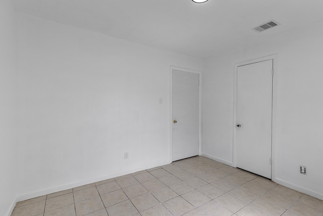 spare room featuring light tile patterned floors