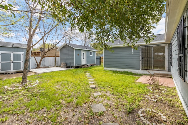 view of yard featuring a patio and a shed