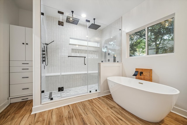 bathroom with separate shower and tub and hardwood / wood-style floors