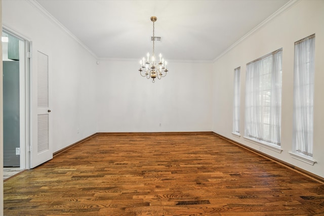 spare room featuring ornamental molding, an inviting chandelier, and dark hardwood / wood-style flooring