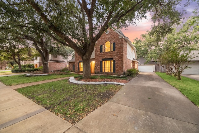 view of front of property featuring a lawn and a garage