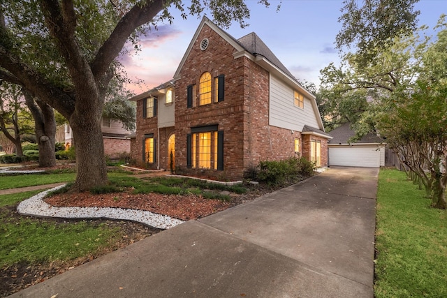 view of front of property with a yard and a garage