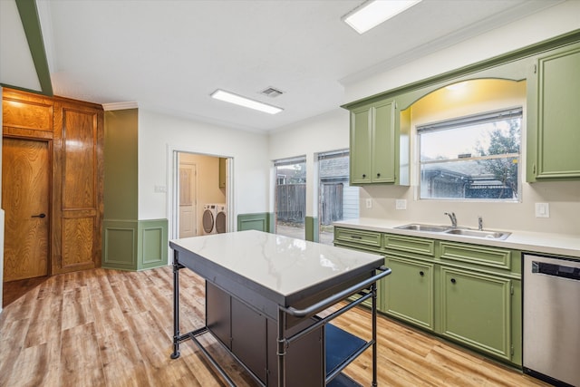 kitchen featuring a healthy amount of sunlight, dishwasher, light hardwood / wood-style flooring, and separate washer and dryer