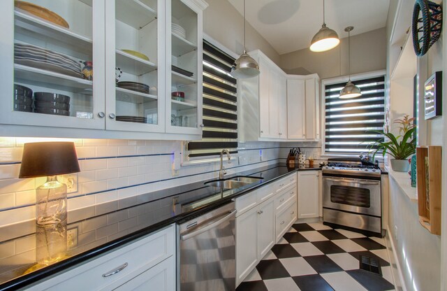 kitchen featuring appliances with stainless steel finishes, pendant lighting, and white cabinets