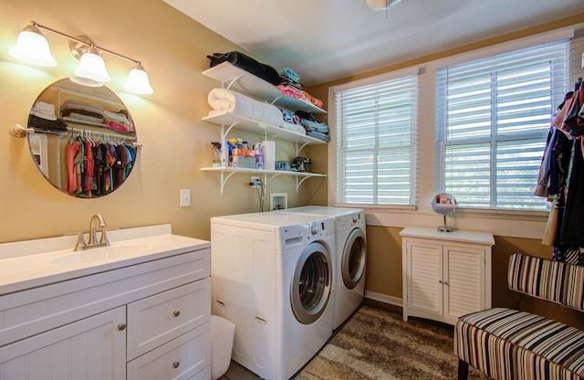 laundry area featuring sink, washer and dryer, cabinets, and a wealth of natural light