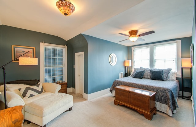 bedroom featuring light carpet, vaulted ceiling, and ceiling fan