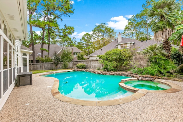 view of pool with an in ground hot tub