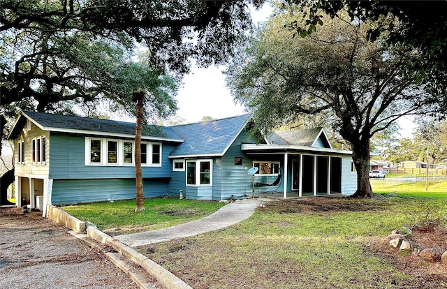 rear view of property featuring a lawn and an attached carport