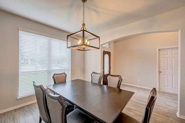 dining area featuring a chandelier and light wood-type flooring