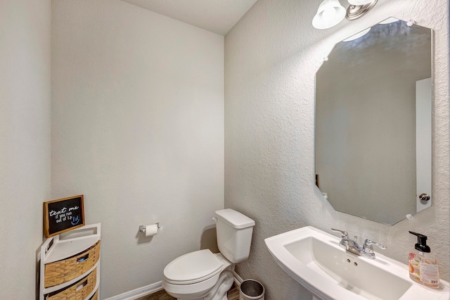 bathroom featuring toilet and sink