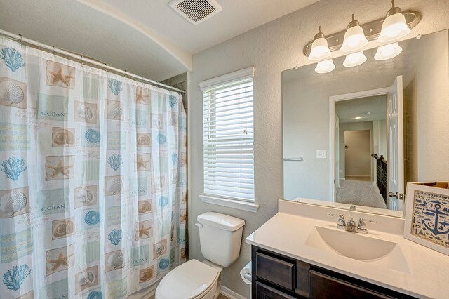 bathroom with vanity, a shower with curtain, and toilet