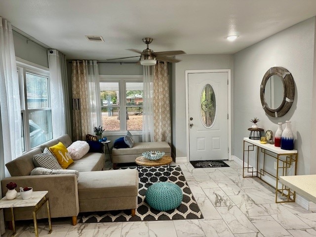 entrance foyer featuring ceiling fan and plenty of natural light