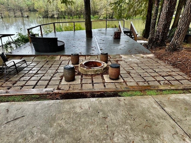 view of patio / terrace featuring a water view and an outdoor fire pit