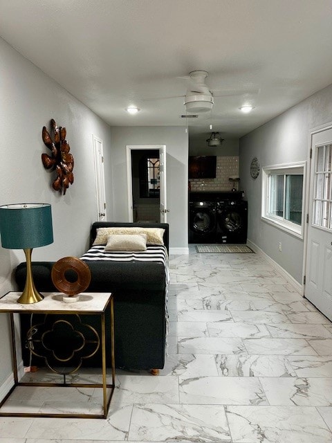 living room with ceiling fan and washer / clothes dryer