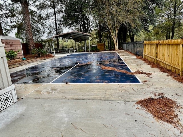 view of pool with a carport