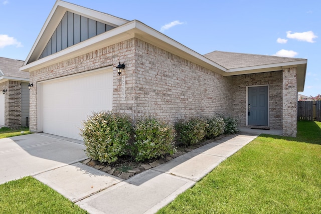 view of front of home with a garage and a front lawn