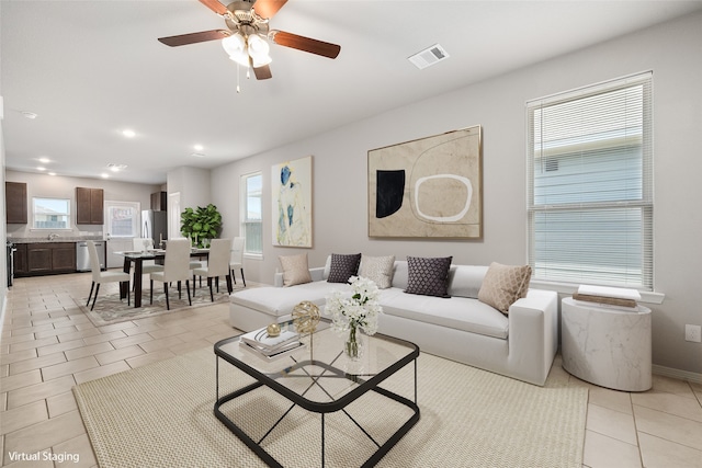 tiled living room with ceiling fan