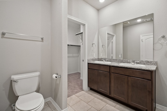 bathroom featuring vanity, toilet, and tile patterned floors