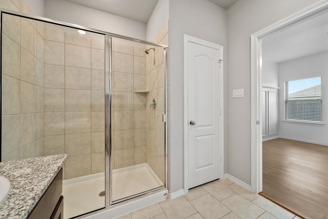 bathroom featuring vanity, wood-type flooring, and walk in shower